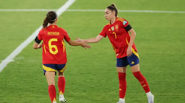 Spain's Aitana Bonmati with Olga Carmona as she comes on as a substitute