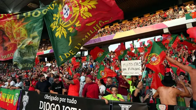 Fans of Portugal wave their national flag in the stand prior to the UEFA Women's EURO 2025 Group B match between Spain and Portugal at Stadion Wankdorf on July 03, 2025 in Bern, Switzerland.