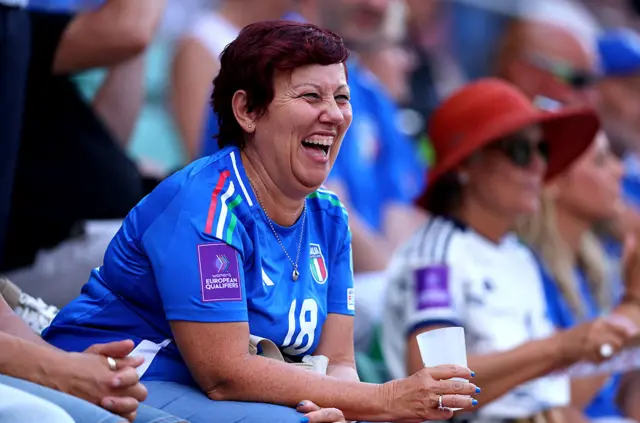 A fan of Italy enjoys the match atmosphere
