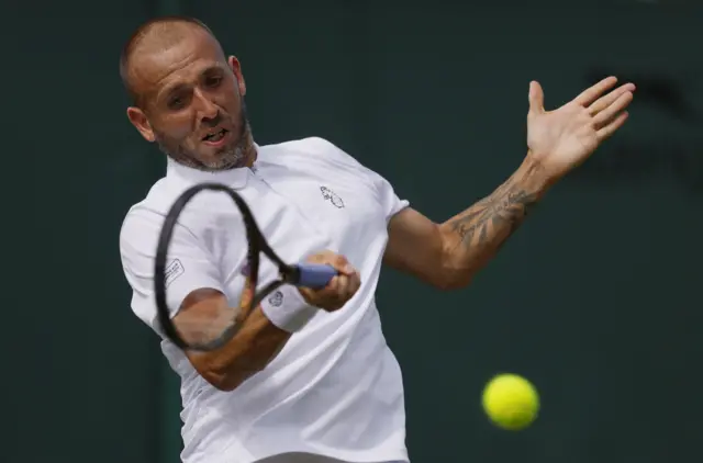 Dan Evans hits a tennis ball
