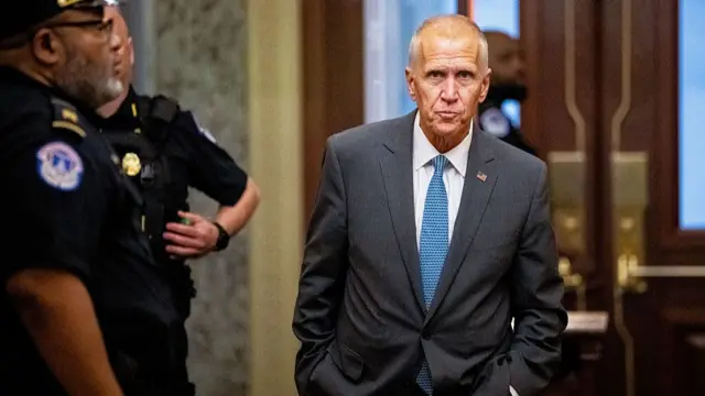 Thom Tillis wearing a grey suit and blue tie