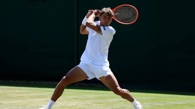 Flavio Cobolli of Italy plays a backhand