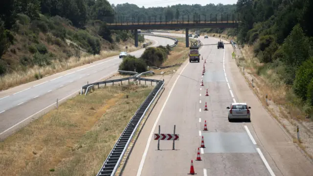 A wide shot of the road, with traffic cones blocking out traffic