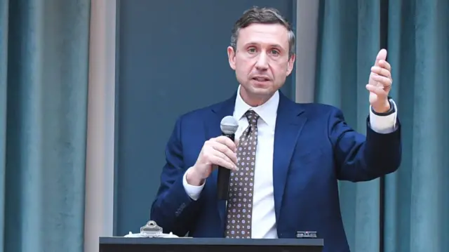 Ken Martin speaks into a microphone