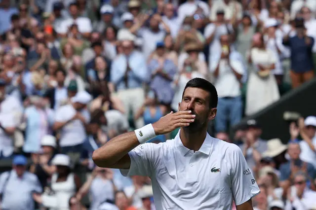 Novak Djokovic kisses his hands