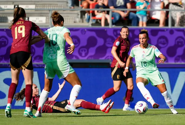 Arianna Caruso controls the ball, as Sari Kees clashes with Cristiana Girelli