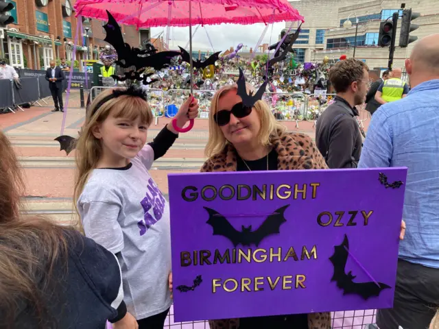 Eliza and her mum with their sign