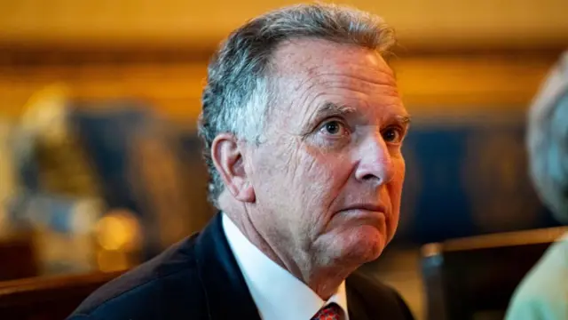 Steve Witkoff is seen in closeup. He wears a neutral expression
