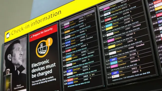 A check-in information board displays details on cancelled flights, after radar failure led to the suspension of outbound flights across the UK, a