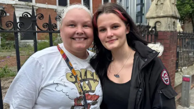 Two women standing outside
