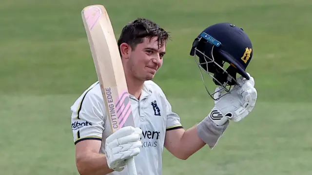 Warwickshire bowler Ethan Bamber celebrates his hundred