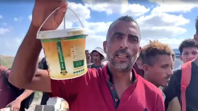 Mohammed Abou Sido holding a jar of tahini