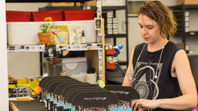 An Earthquaker Devices employee inspects products