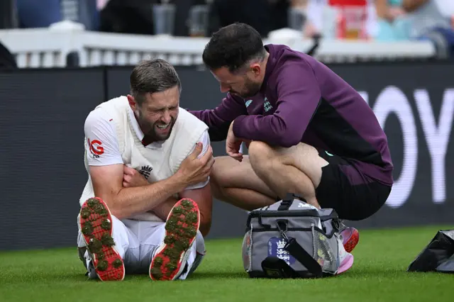 Chris Woakes holds his shoulder