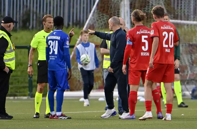 Rodney McAree speaks to the match referee