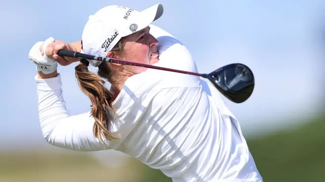 Lottie Woad hits a drive