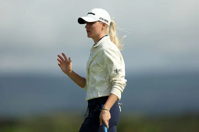 Charley Hull holds her ball up to acknowledge the crowd