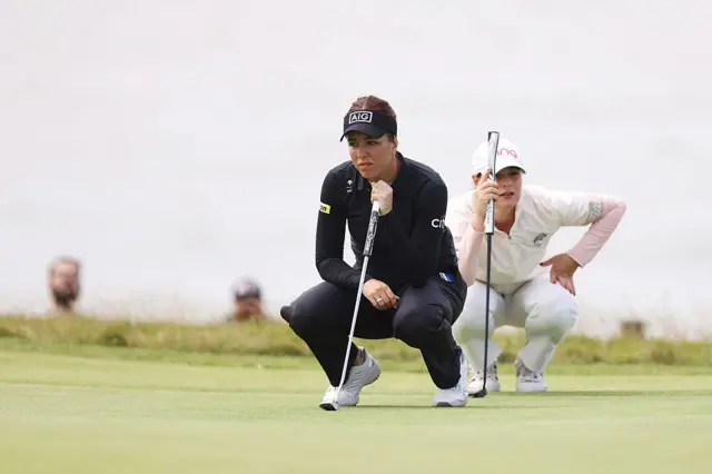 Georgia Hall lines up a putt