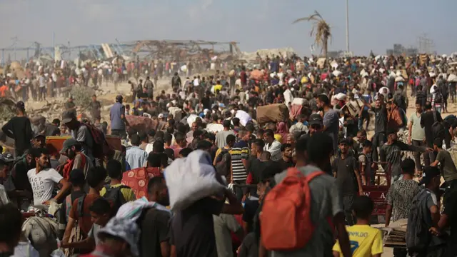 A crowd of Palestinians rushes toward humanitarian aid distribution points