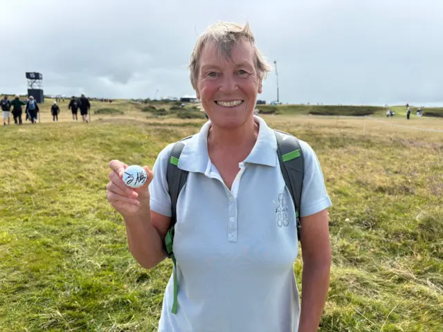Dee Shorney poses with her signed golf ball