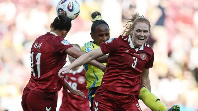 Katrine Veje of Denmark and Stine Ballisager of Denmark competes for the ball with Madelen Janogy of Sweden during the UEFA Womens EURO 2025 Group C match between Denmark and Sweden at Stade de Geneve