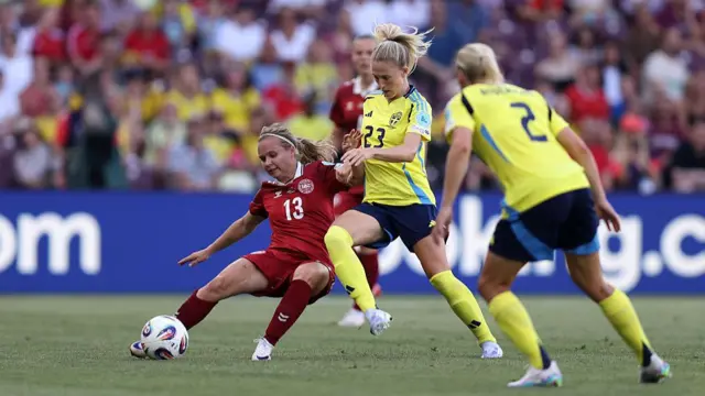 Cornelia Kramer of Denmark battles for possession with Rebecka Blomqvist of Sweden during the UEFA Women's EURO 2025 Group C match between Denmark and Sweden at Stade de Geneve
