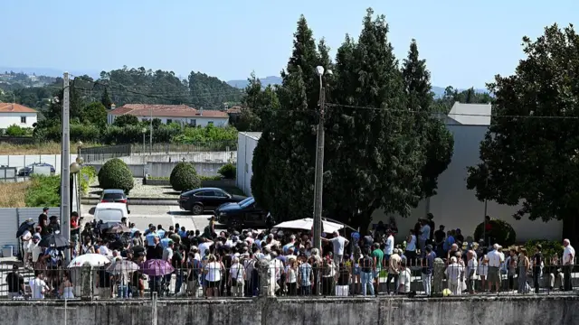 Dozens of people waiting near the chapel