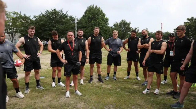 Matt Sherratt standing in the middle of a Wales huddle