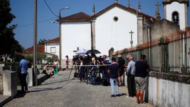Dozens of press and a few TV cameras gather outside the Chapel of the Resurrection