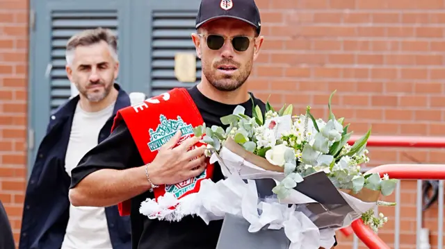 Jordan Henderson with flowers in tribute