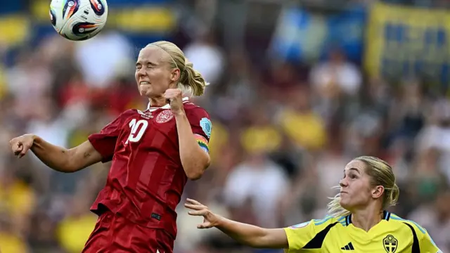Pernille Harder (L) fights for the ball with Sweden's defender #04 Hanna Lundkvist during the UEFA Women's Euro 2025 Group C football match between Denmark and Sweden