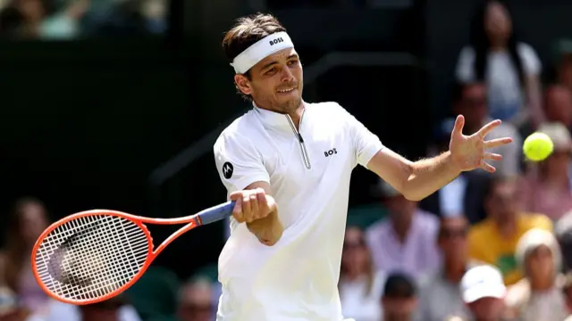 Taylor Fritz plays a forehand