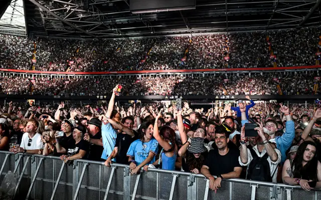 Thousands of fans watch on as Oasis play on stage at the Principality.
