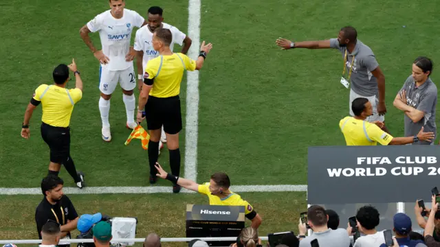 The referee looks at the VAR monitor during the match between Fluminense and Al-Hilal