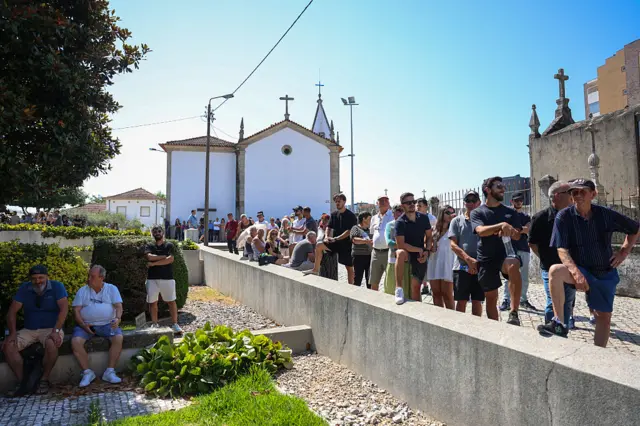 Members of the public standing in the line outside the chapel