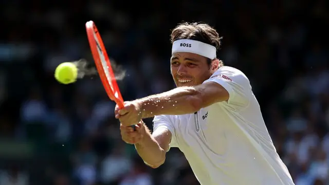 Taylor Fritz plays a backhand