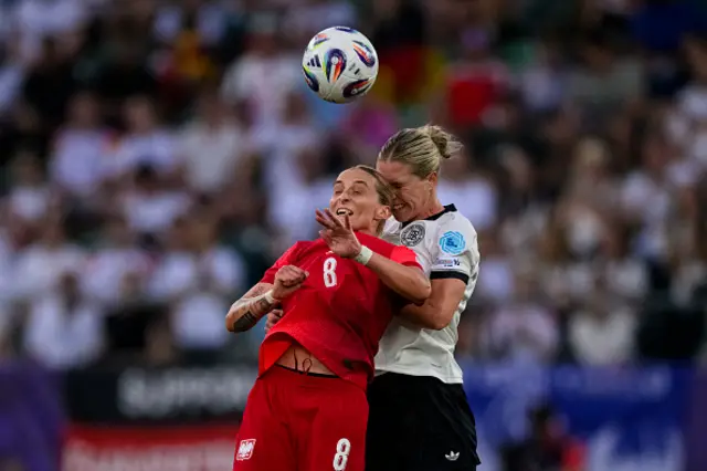 Ewelina Kamczyk of Poland (L) fights for heading the ball with Rebecca Knaak