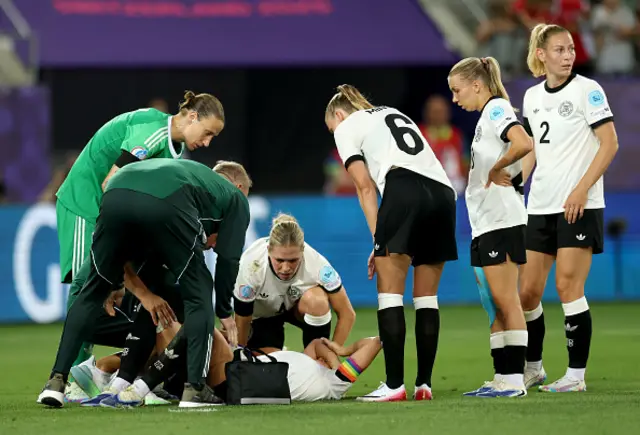 Giulia Gwinn of Germany receives medical treatment