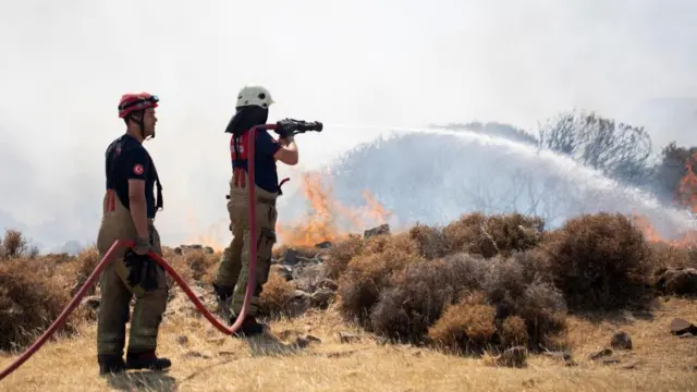 Firefighters tackle a wildfire in Izmir Province