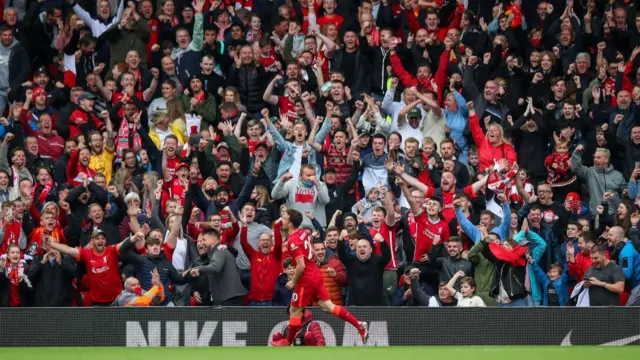 Diogo Jota celebrates in front of Liverpool fans after a goal