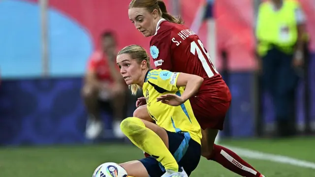Sweden's defender #04 Hanna Lundkvist fights for the ball with Denmark's defender #18 Sara Holmgaard during the UEFA Women's Euro 2025 Group C football match between Denmark and Sweden at the Stade de Geneve in Geneva