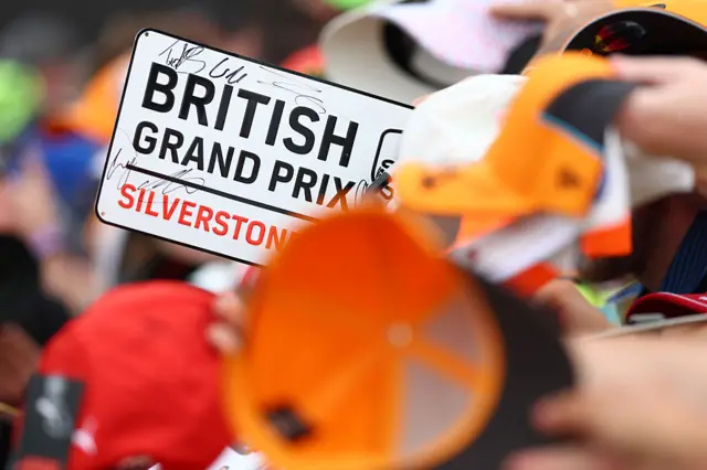 A fan holds up a British Grand Prix sign