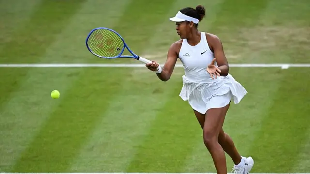 Naomi Osaka plays a forehand return