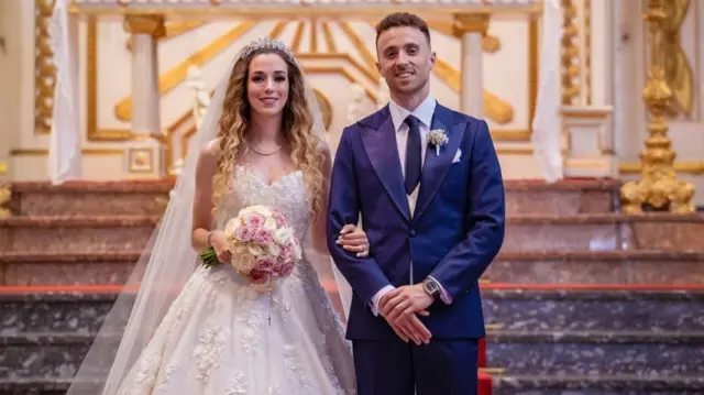 Diogo Jota stands next to his bride