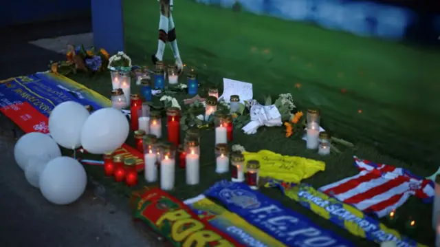 Flowers and candles lie in tribute to Liverpool's Portuguese soccer player Diogo Jota