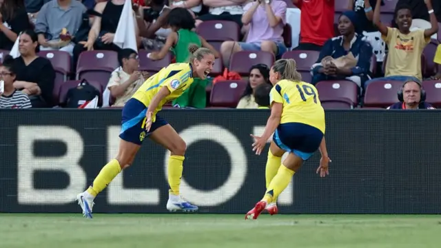 Filippa Angeldahl of Sweden (L) celebrates after scoring her team's first goal with Johanna Rytting Kaneryd of Sweden (R) during the UEFA Womens EURO 2025 Group C match between Denmark and Sweden at Stade de Geneve