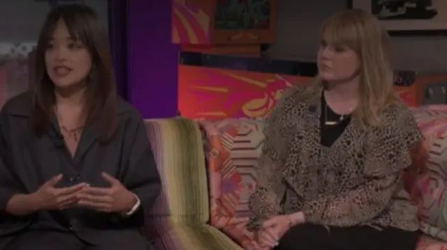 Dr Chen-Yu Lin sits on a sofa next to a presenter