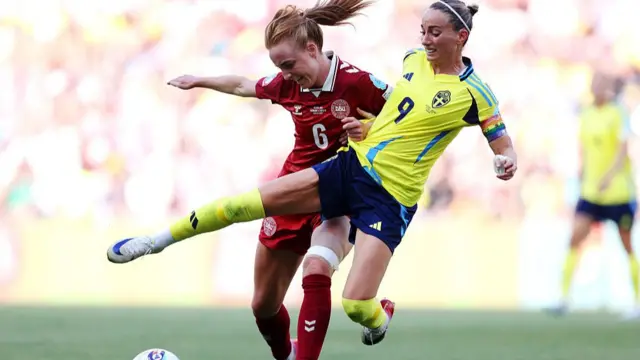 Karen Holmgaard of Denmark is challenged by Kosovare Asllani of Sweden during the UEFA Women's EURO 2025 Group C match between Denmark and Sweden at Stade de Geneve
