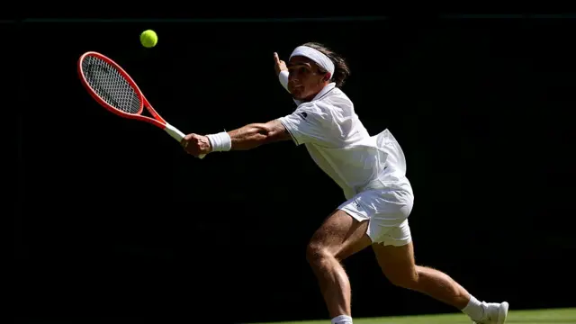 Mattia Bellucci of Italy plays a backhand against Cameron Norrie