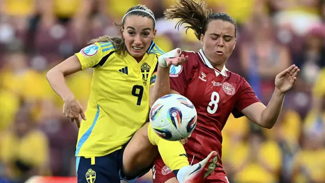 Sweden's forward #09 Kosovare Asllani fights for the ball with Denmark's midfielder #08 Emma Snerle during the UEFA Women's Euro 2025 Group C football match between Denmark and Sweden